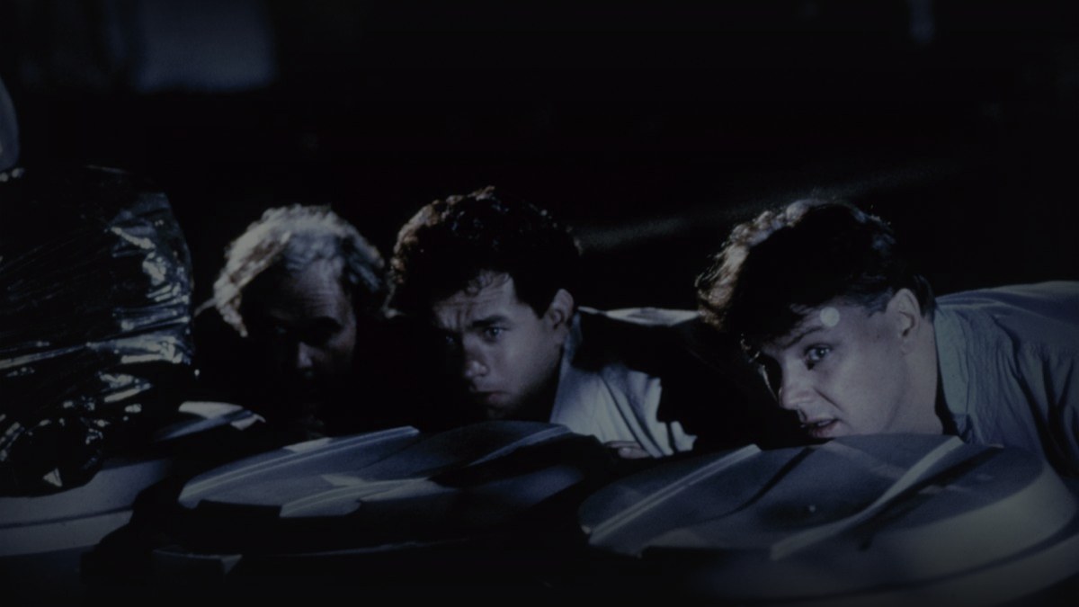 Still from The 'Burbs (1989) — letterboxd still from The 'Burbs (1989), checked against MoMA and Universal press stills; pre-brightened 1.15, baked through scripts/bake_dark_photo.py at factor 0.45, output brightness 19.7